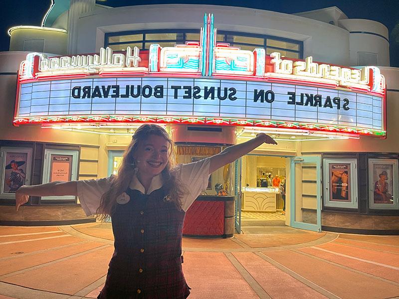 Young woman in front of movie theater at Disney World